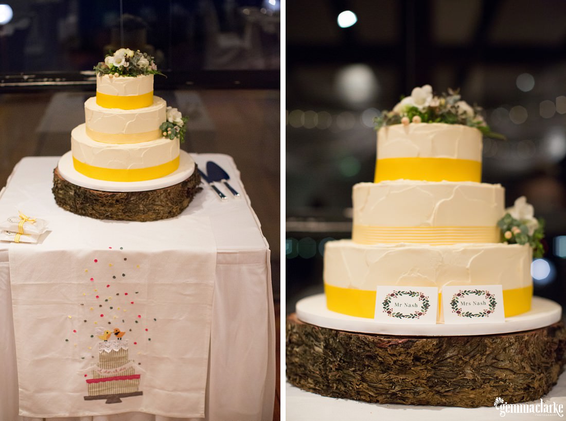 Three tiered naked wedding cake with yellow trimming and floral decorations - The Rocks Wedding