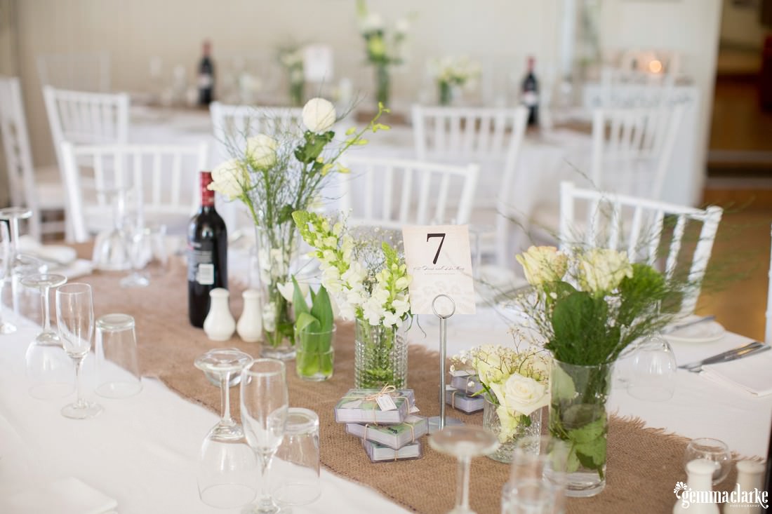 Wedding reception setup with hessian table runners and floral centrepieces - Southern Highlands Wedding