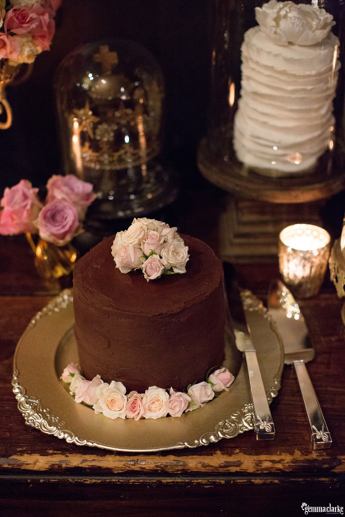 A single tier chocolate cake with floral decorations - Echoes Hotel Wedding