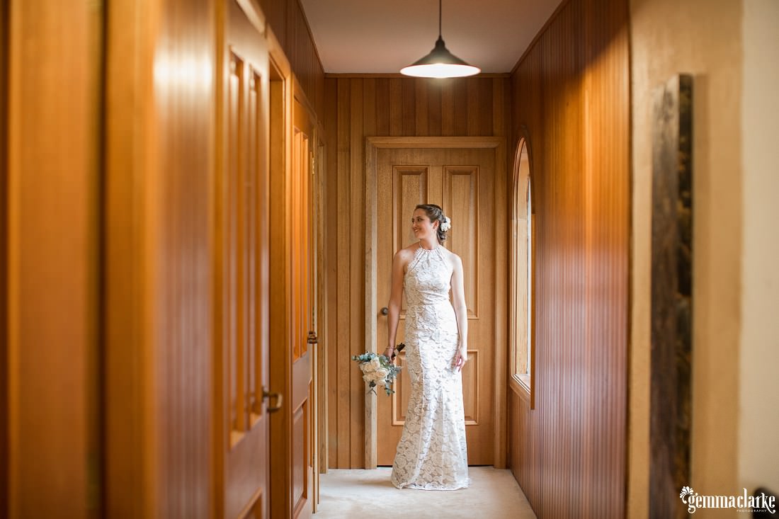 A bride posing in a wooden hallway - Rainy Athol Hall Wedding