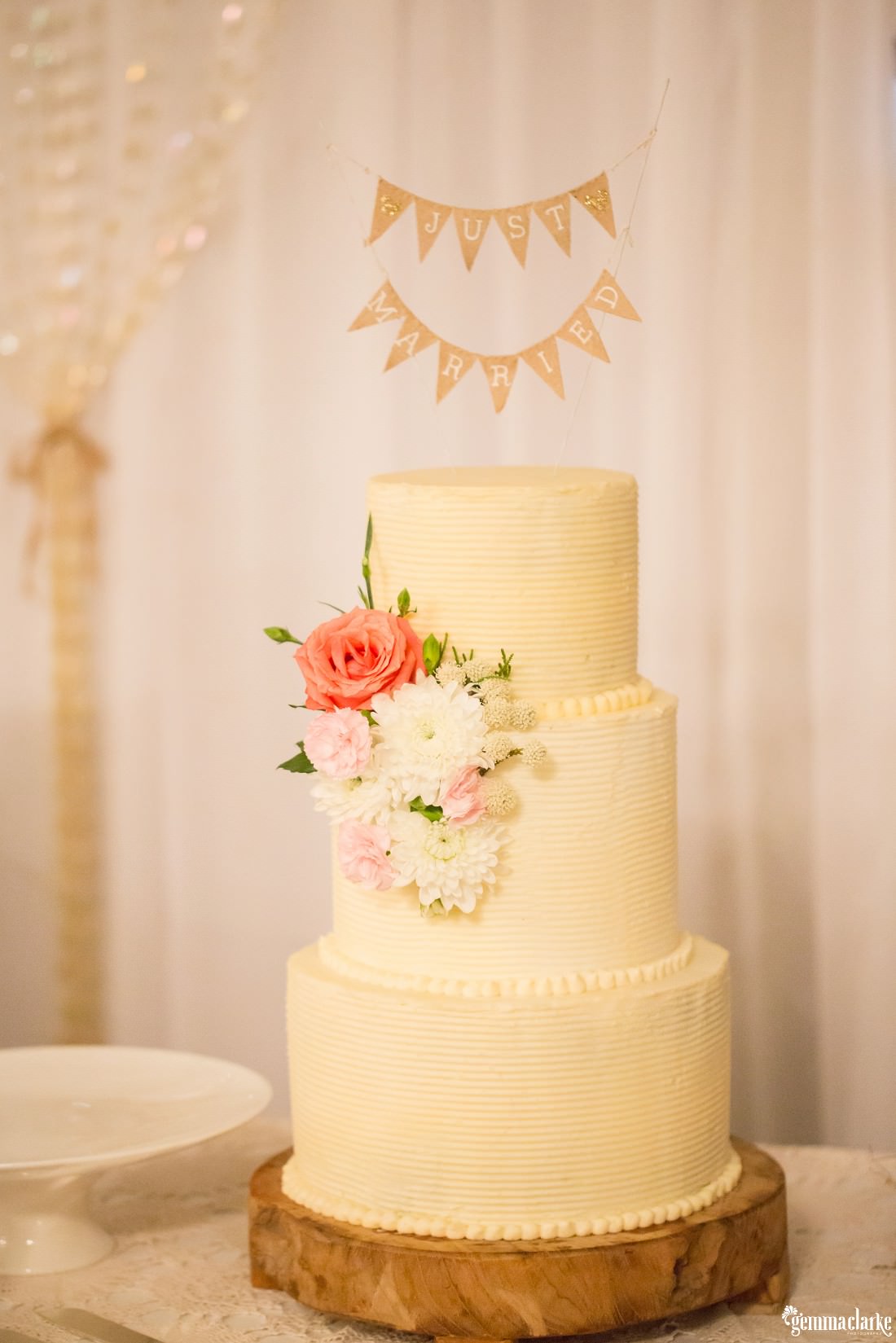 Three tier white wedding cake with floral decoration - Camden Wedding
