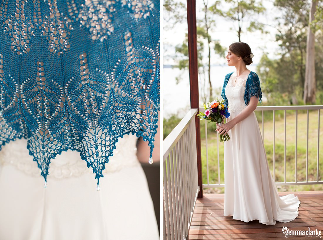 A bride posing on a verandah in her flowing bridal gown and handmade blue beaded shawl - The Newcastle Club