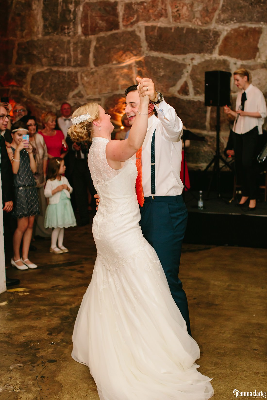 A smiling groom dancing with his bride