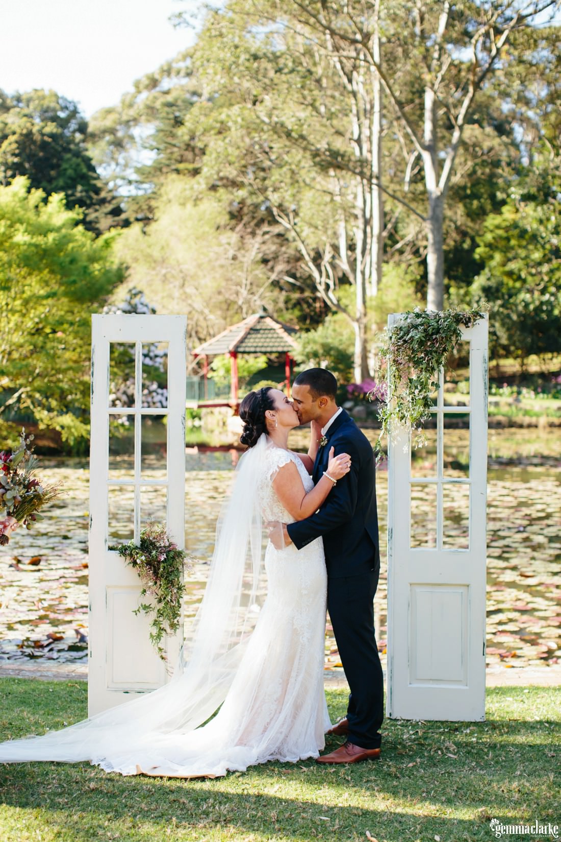 A bride and groom kiss at their ceremony