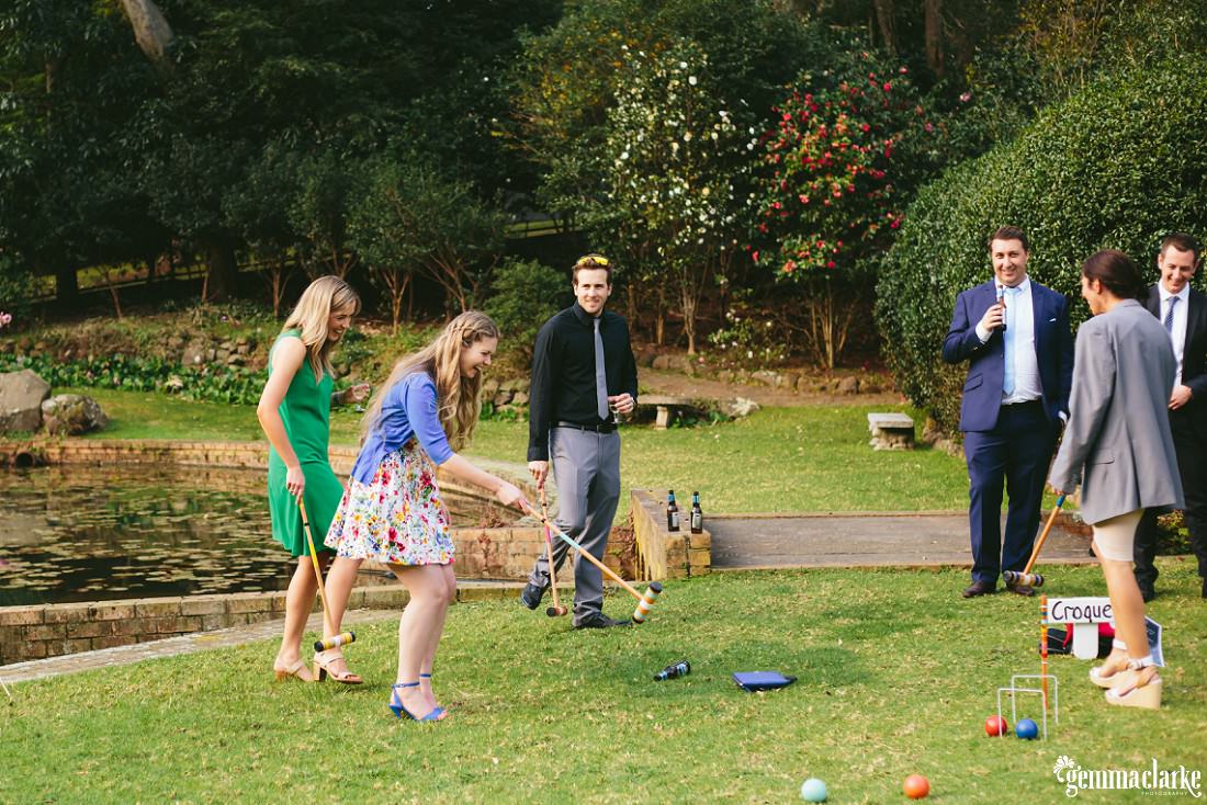 Wedding guests playing croquet