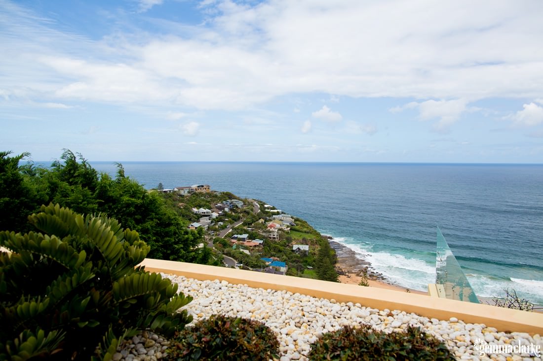 An ocean view over a headland from a balcony