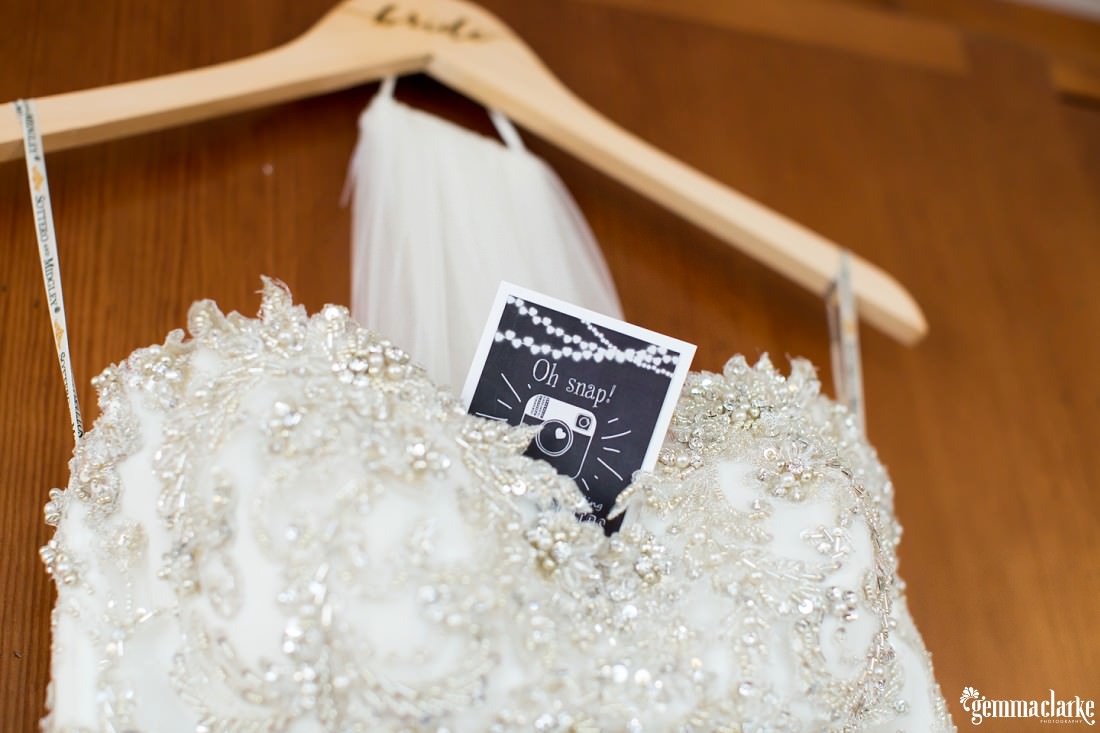 A closeup of the top section of a wedding dress showing lots of detail