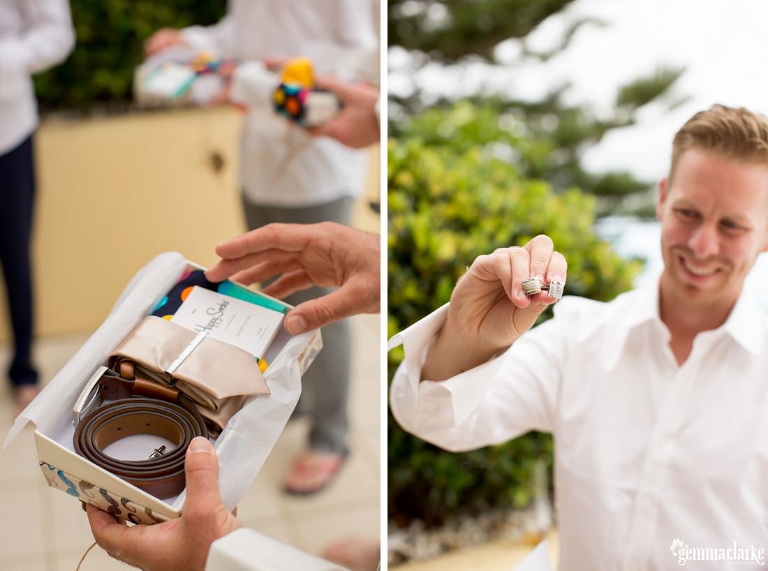 Groomsmen opening their gift boxes to find accessories inside, including a tie and tie pin, belt, socks and cuff links 