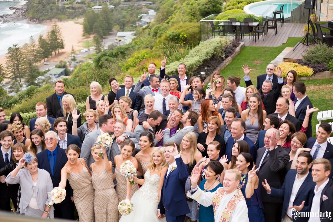 A group shot of a wedding party and their guests in various funny poses