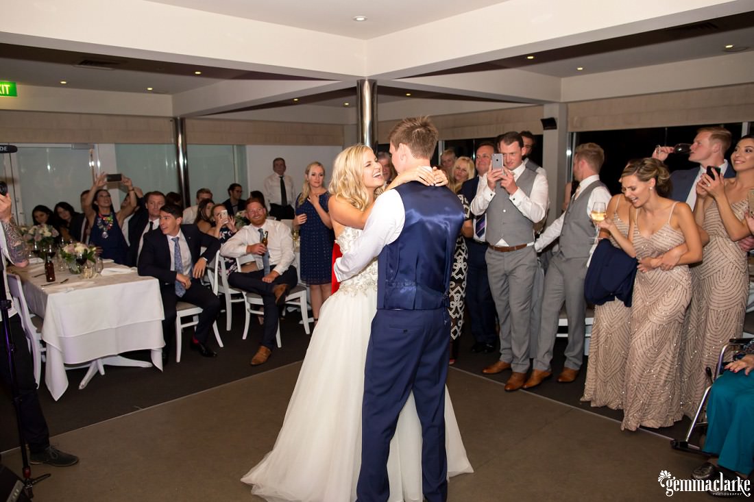 A bride and groom share their first dance