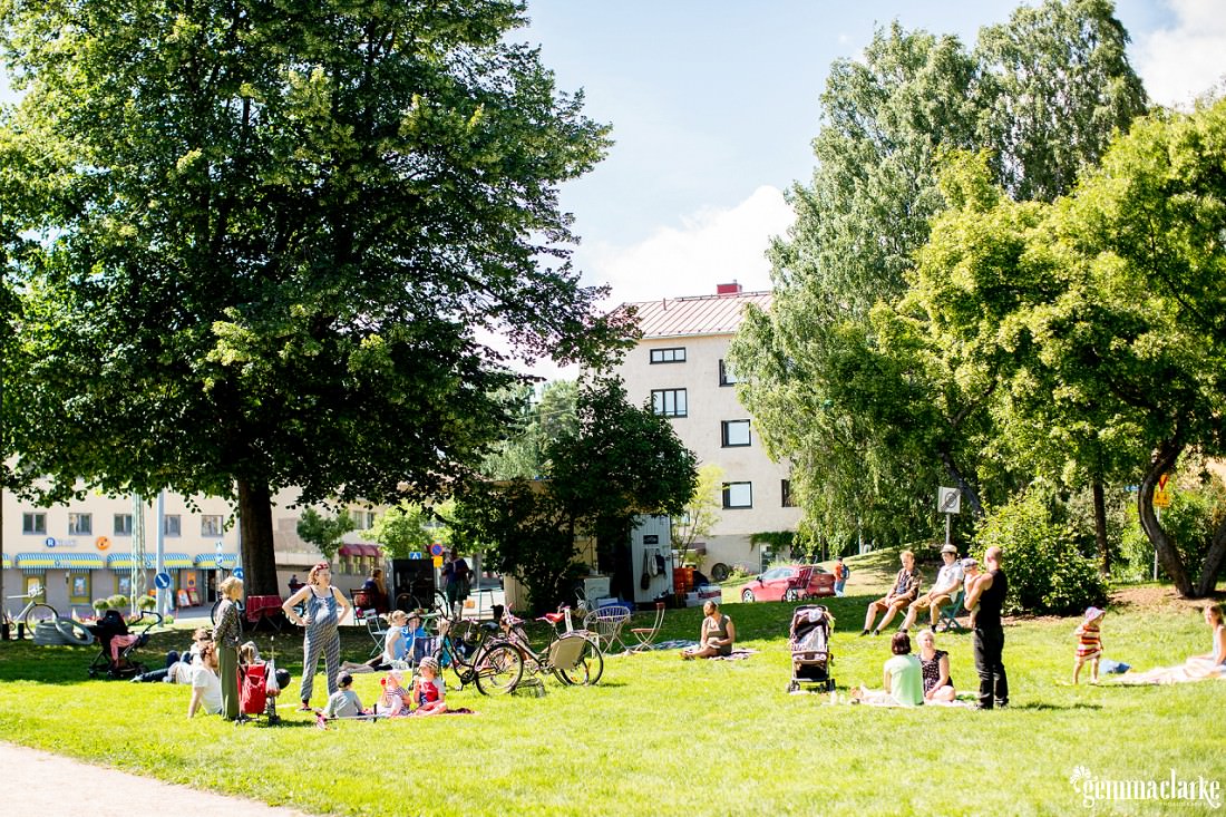 People sitting in a park on a bright, sunny day