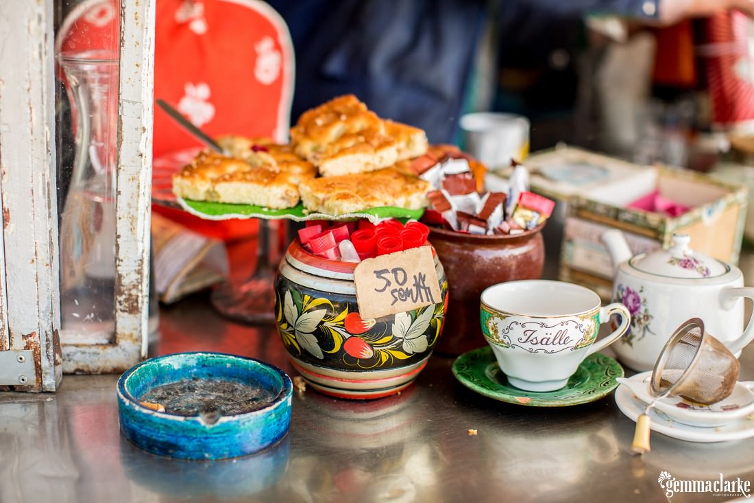 Cafe food, mugs, a teapot and an ashtray