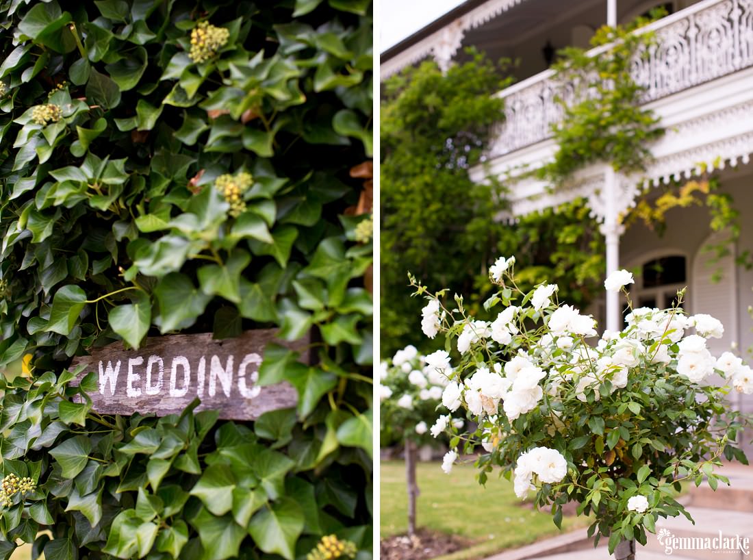 A painted Wedding sign and some white flowers