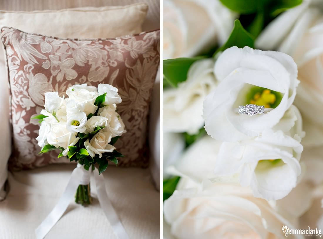 An engagement ring sitting on a white flower in a bridal bouquet