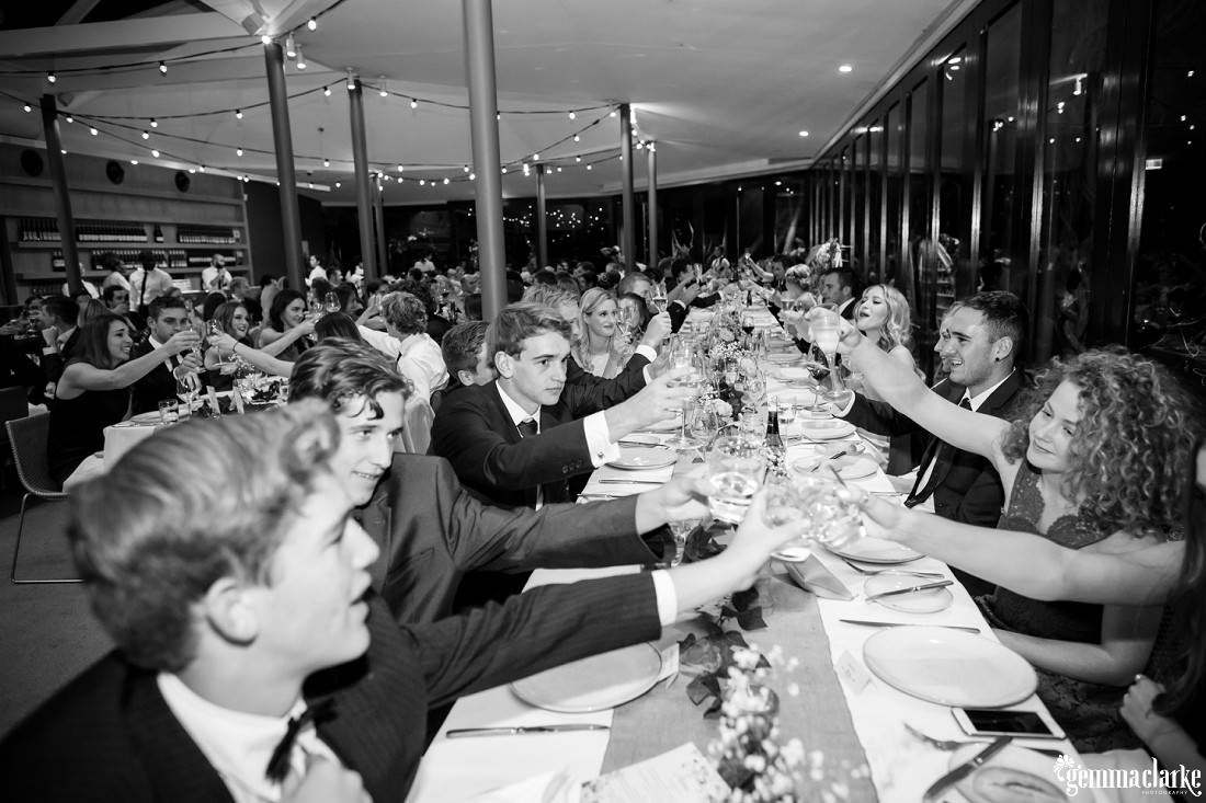 Wedding guests raise their glasses for a toast