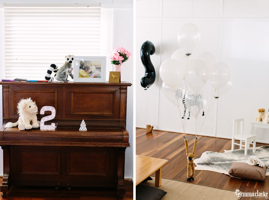 Decorations of animals and balloons in the party room and on the piano