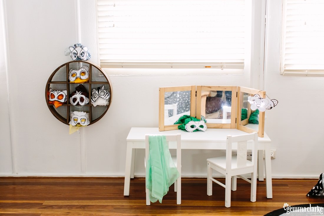 A cute setup of the animals masks and chairs and table with mirrors so the children can see themselves with the masks on.