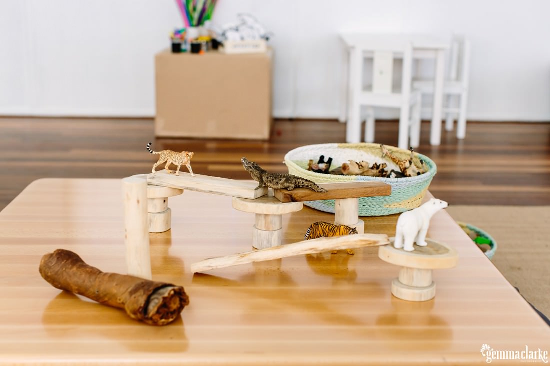 Toy animals displayed on a wooden table for the children to play with