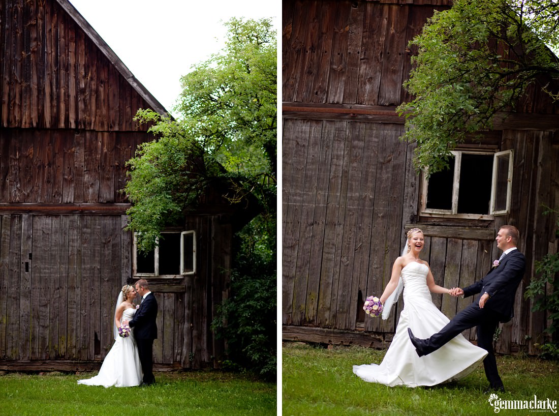 A posing bride and groom outside an old wooden barn - German Country Wedding