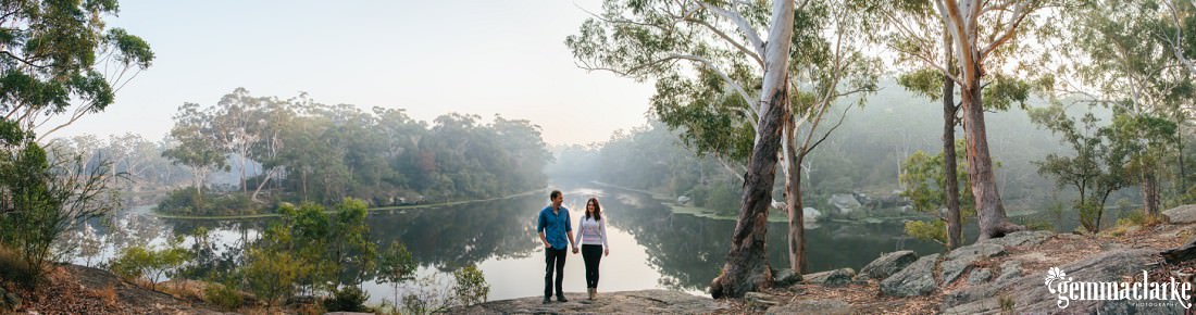 A spectacular panorama photo of the couple at Lake Parramatta where they are very small in the middle of the image and then the bush and lake surrounding them - Lake Parramatta