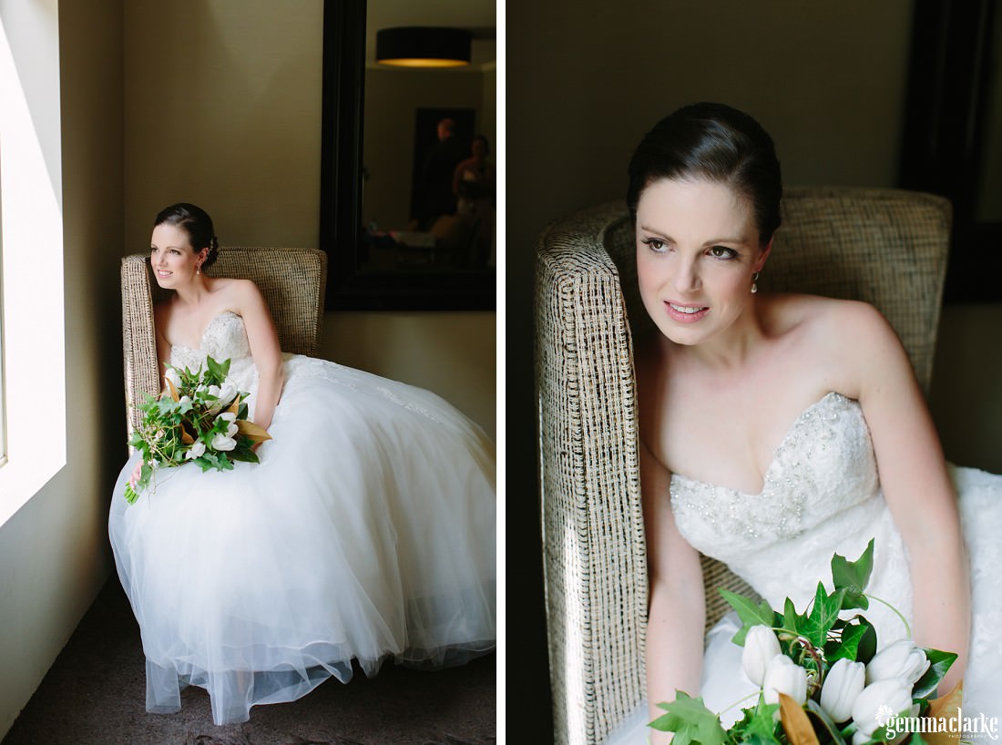 A bride posing on a chair by a window
