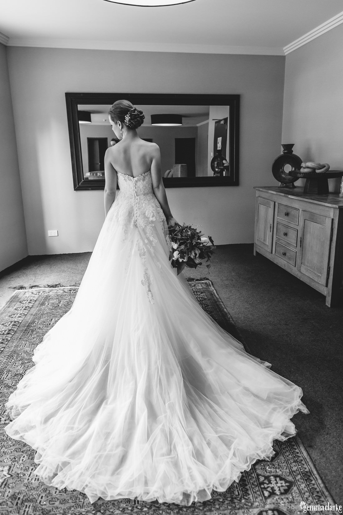 A bride posing in front of a mirror