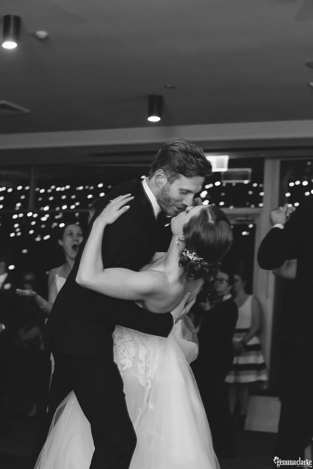 A groom dipping his bride during their first dance
