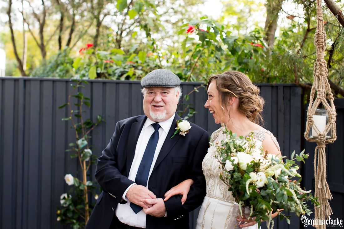 A smiling bride with her father