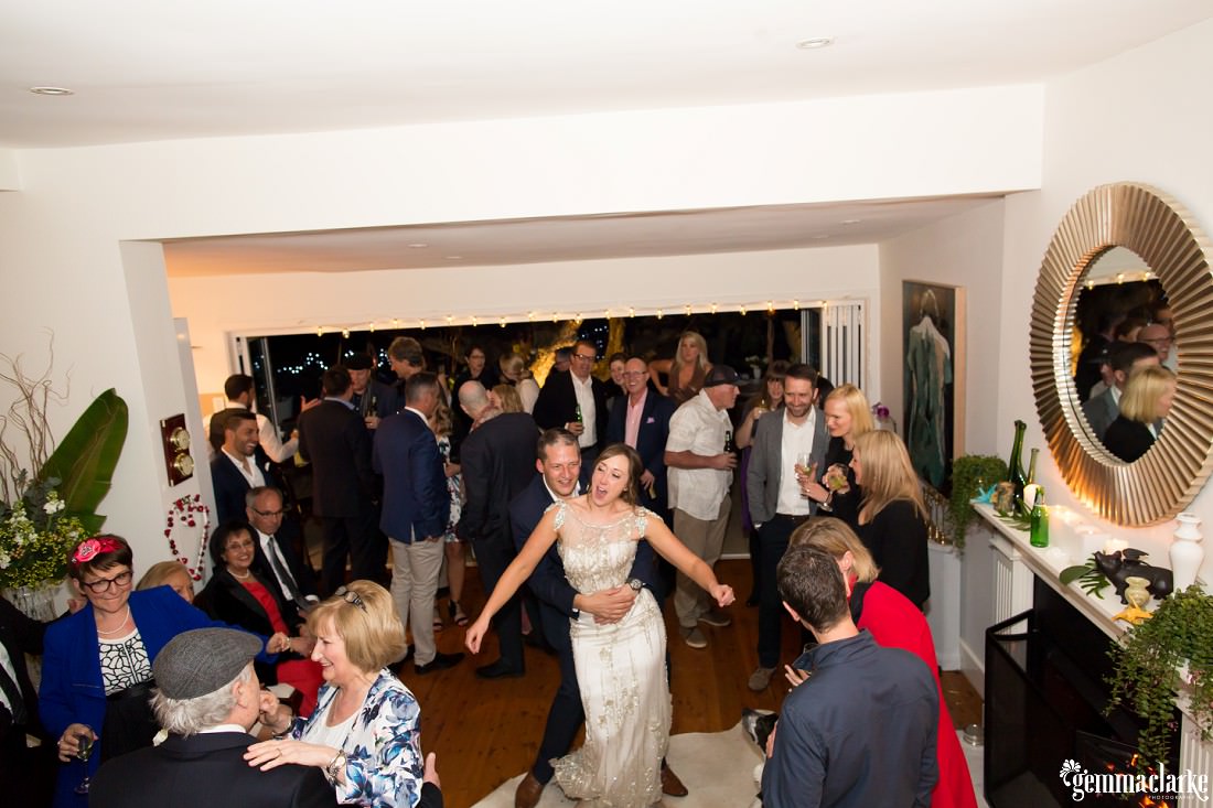 Bride and Groom pulling some serious dance moves in this wedding at home in their living room!