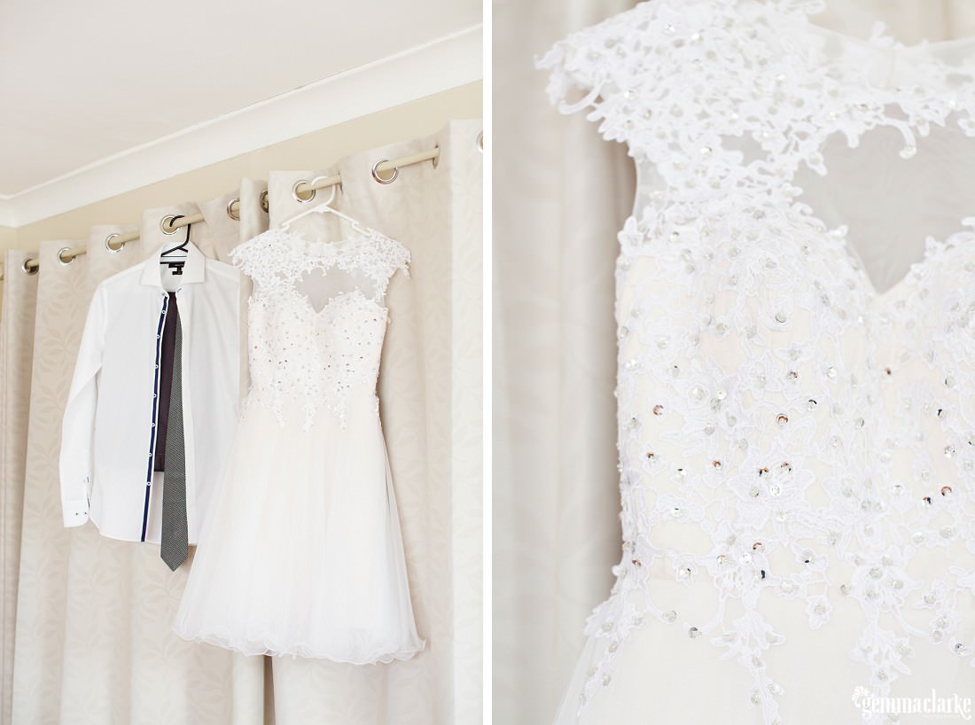 A sequined white bridal gown hanging next to a white man's shirt with tie