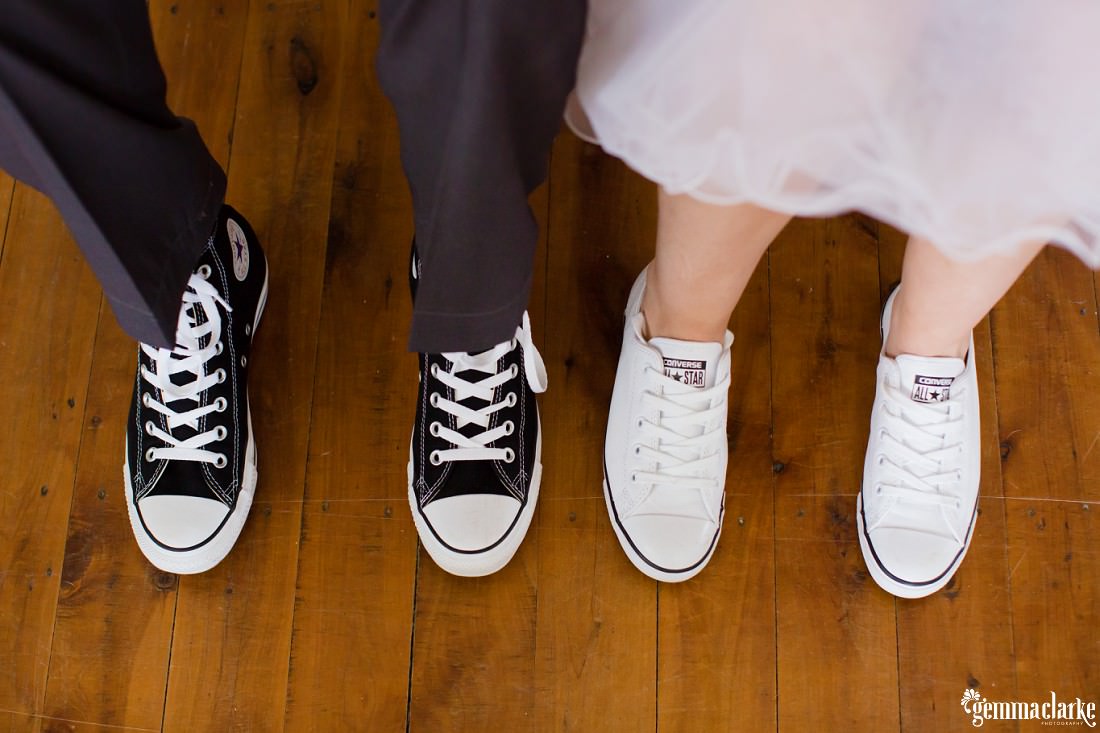 A bride and groom's feet in Converse Chuck Taylor All Stars