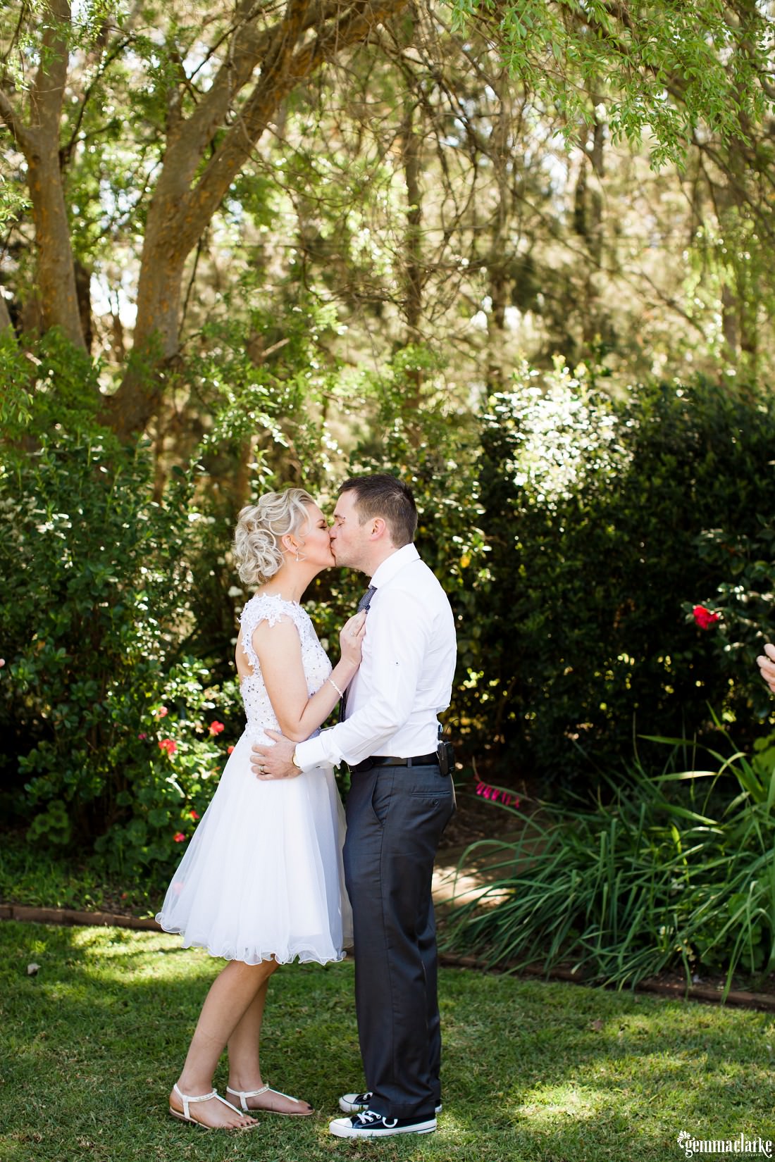 A bride and groom kiss at their wedding ceremony