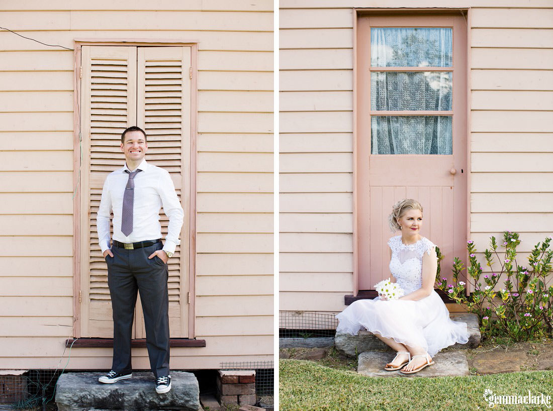 A bride sitting on a step in front of a pale pink door and some white and purple flowers and a smiling groom standing on a step in front of a pale pink door