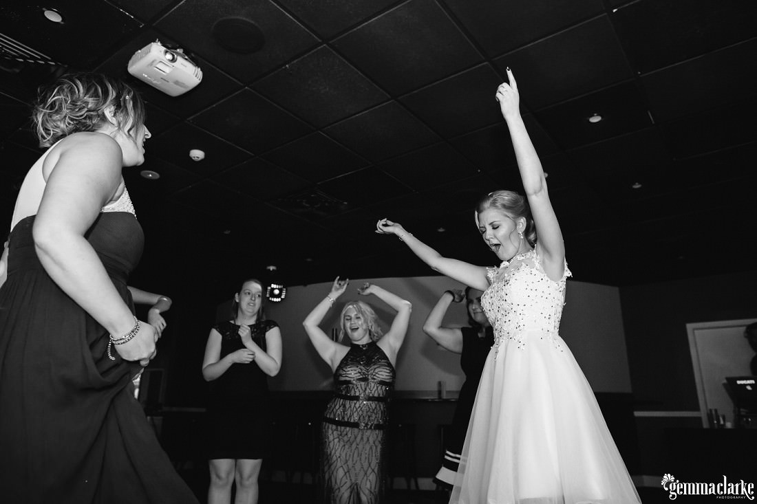 A bride and wedding guests making moves on the dancefloor