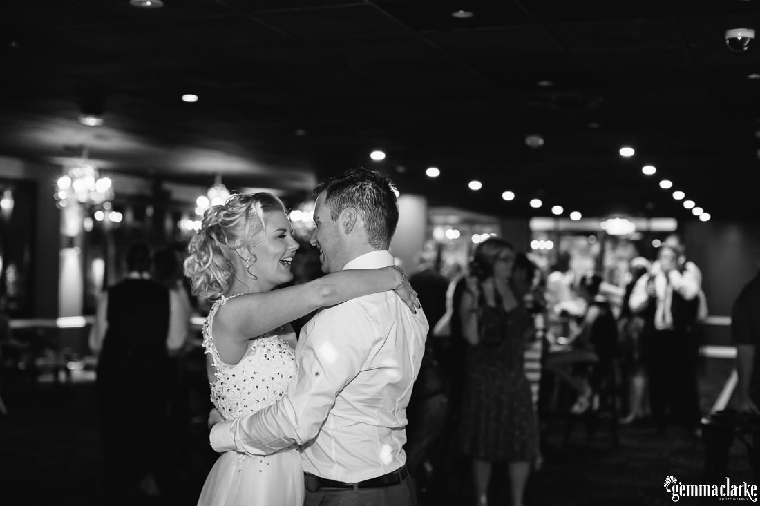 A bride and groom dancing together