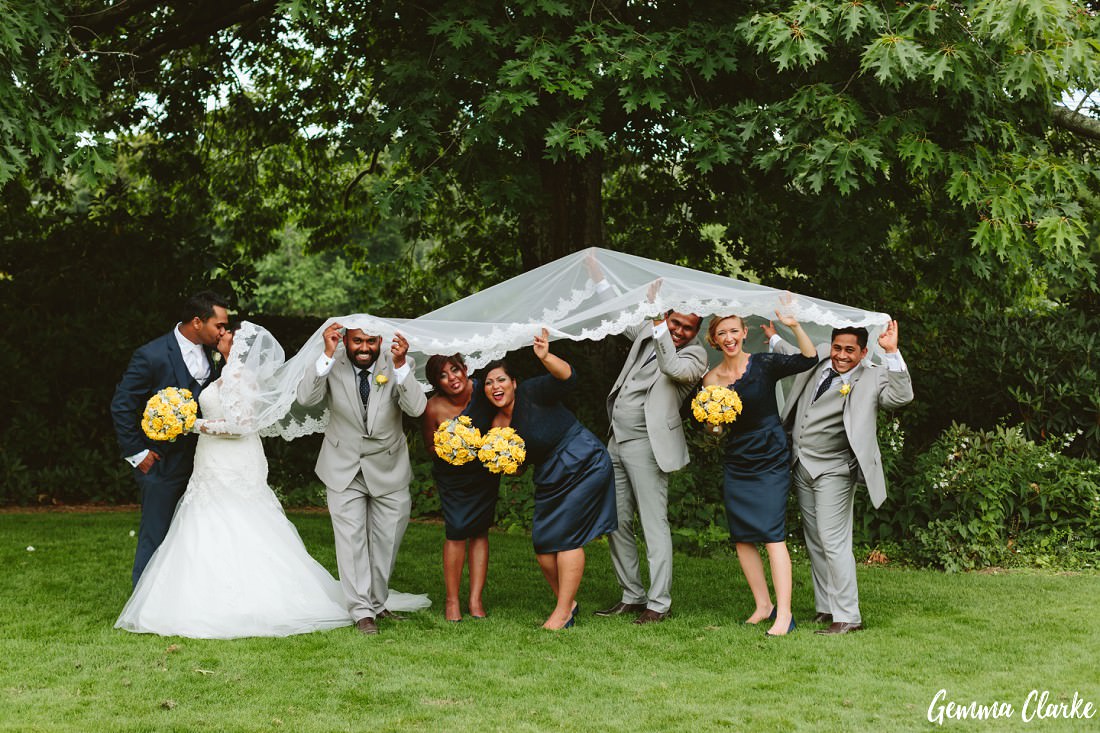 Fun bridal party hiding under the bride's very long veil and pulling funny face - 2016 highlights
