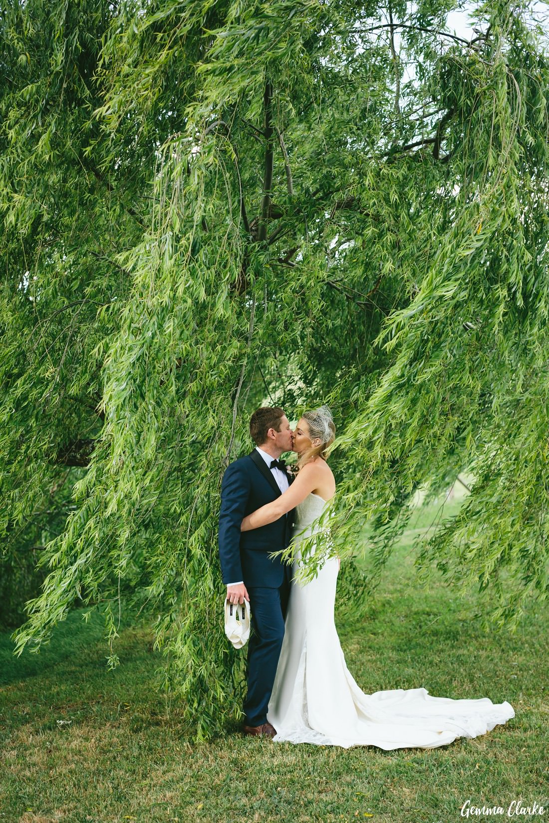 Bride and Groom kissing amongst an overhanging large tree at this Bendooley Estate Wedding