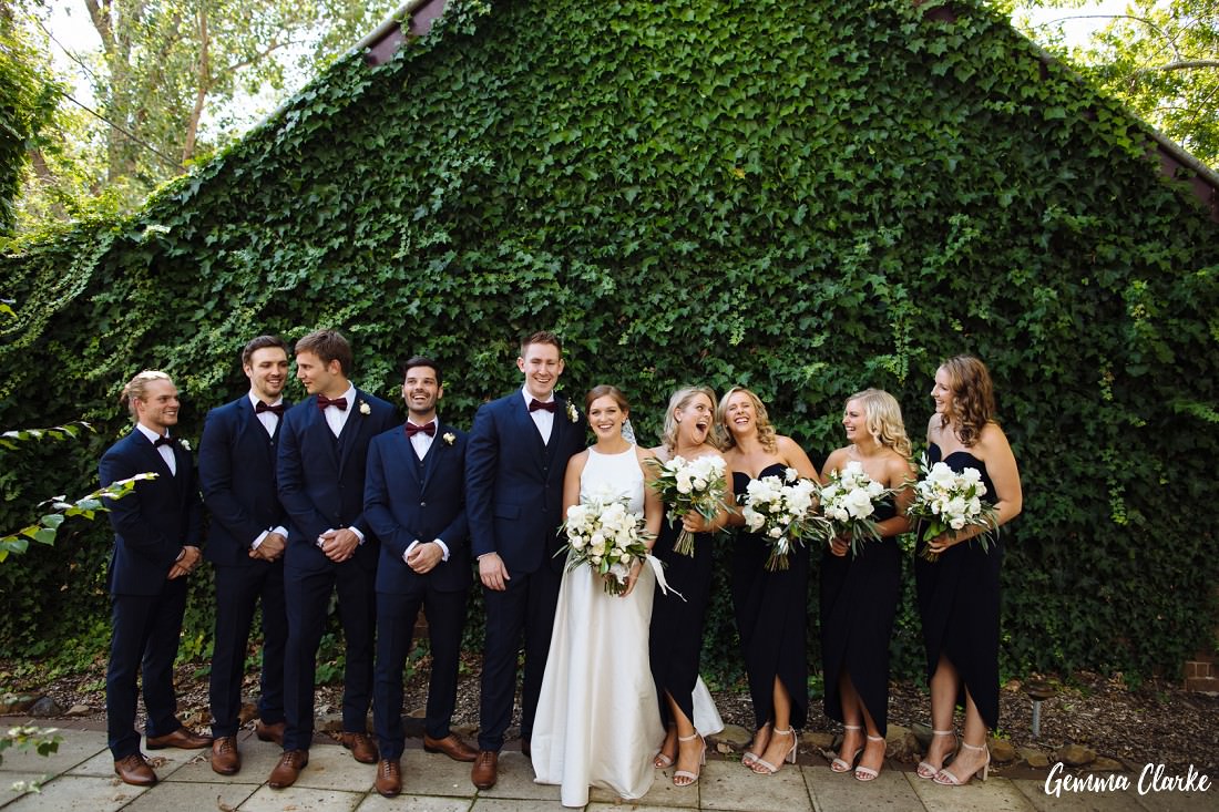 Bridal party fun in front of a vine covered wall at this Peppers Manor House Wedding