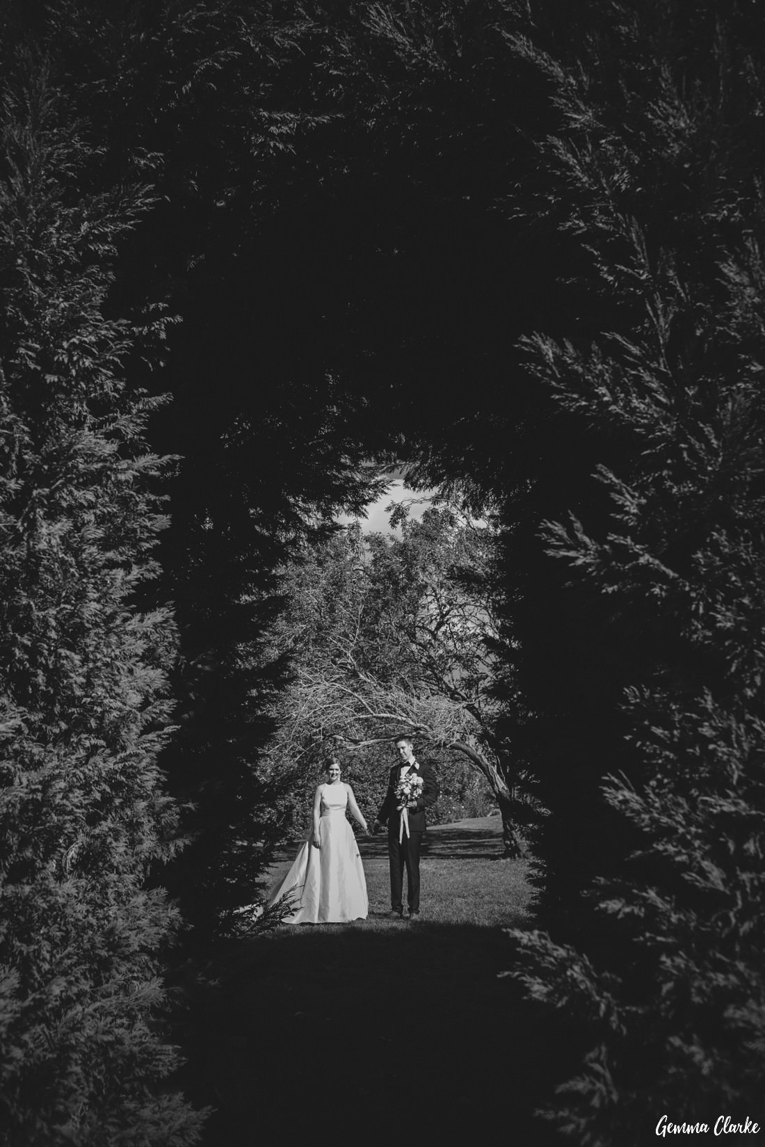 Black and white with bride and groom in arch Peppers Manor House Wedding