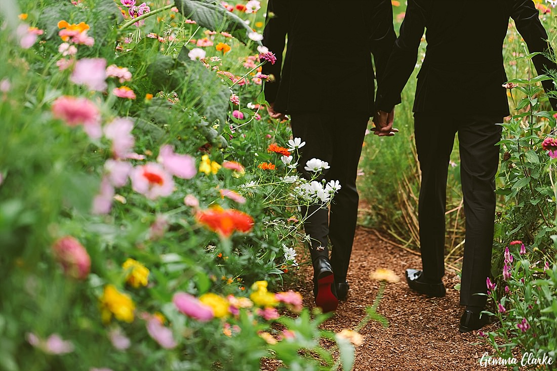 Pascal and Richard walking hand in hand through the wildflower garden in the Royal Botanic Gardens at this Sydney Gay Wedding