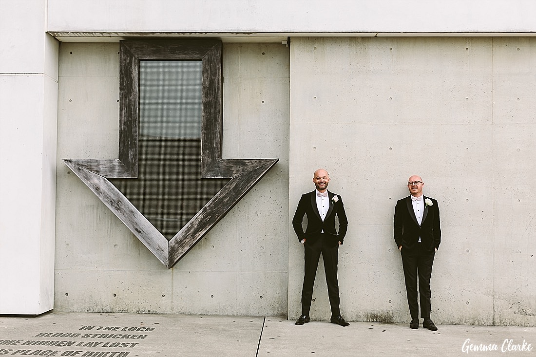 Pascal and Richard in their matching tuxedos in front of the infamous arrow at the MCA at this Sydney Gay Wedding