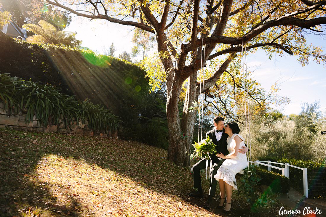 Bride and Groom have a romantic moment on the swing as the sun streams through the leaves at this Loxley on Bellbird Hill Wedding