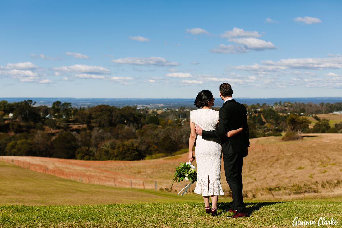 Anna Maria and Eric look over the rolling hills of the countryside from the lower gardens at the Loxley on Bellbird Hill Wedding