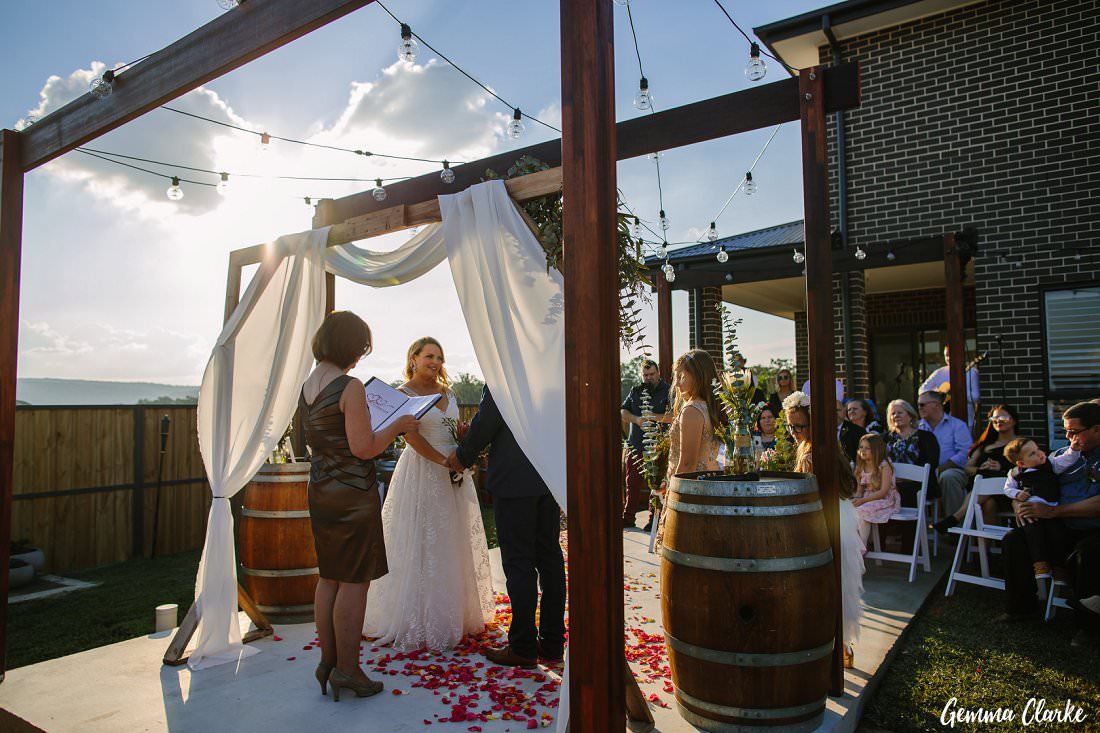 bride and groom exchange vows in front of 30 of their closest friends and family at this western sydney backyard wedding