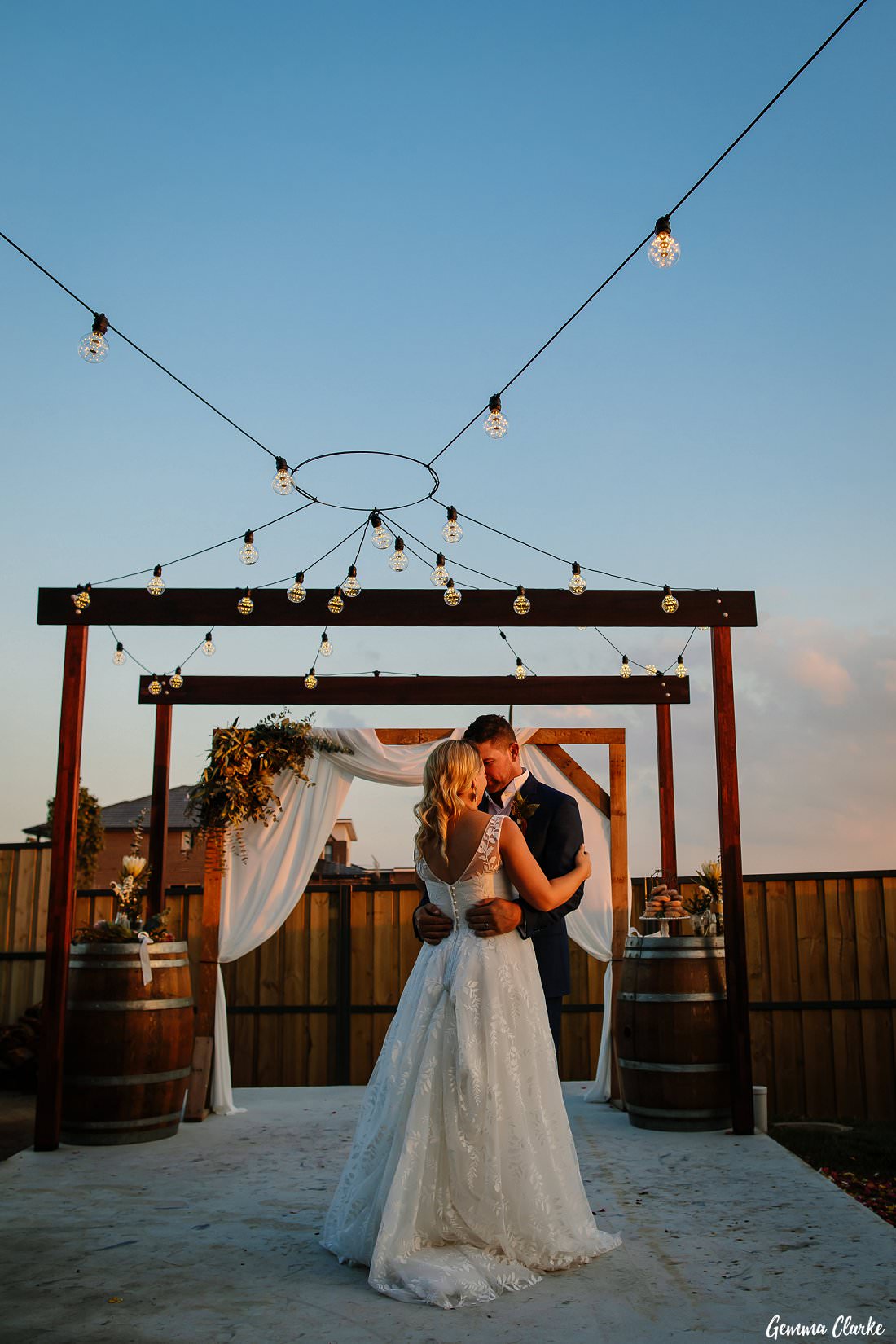 the first dance under their DIY structure and festoon lights at this western sydney backyard wedding