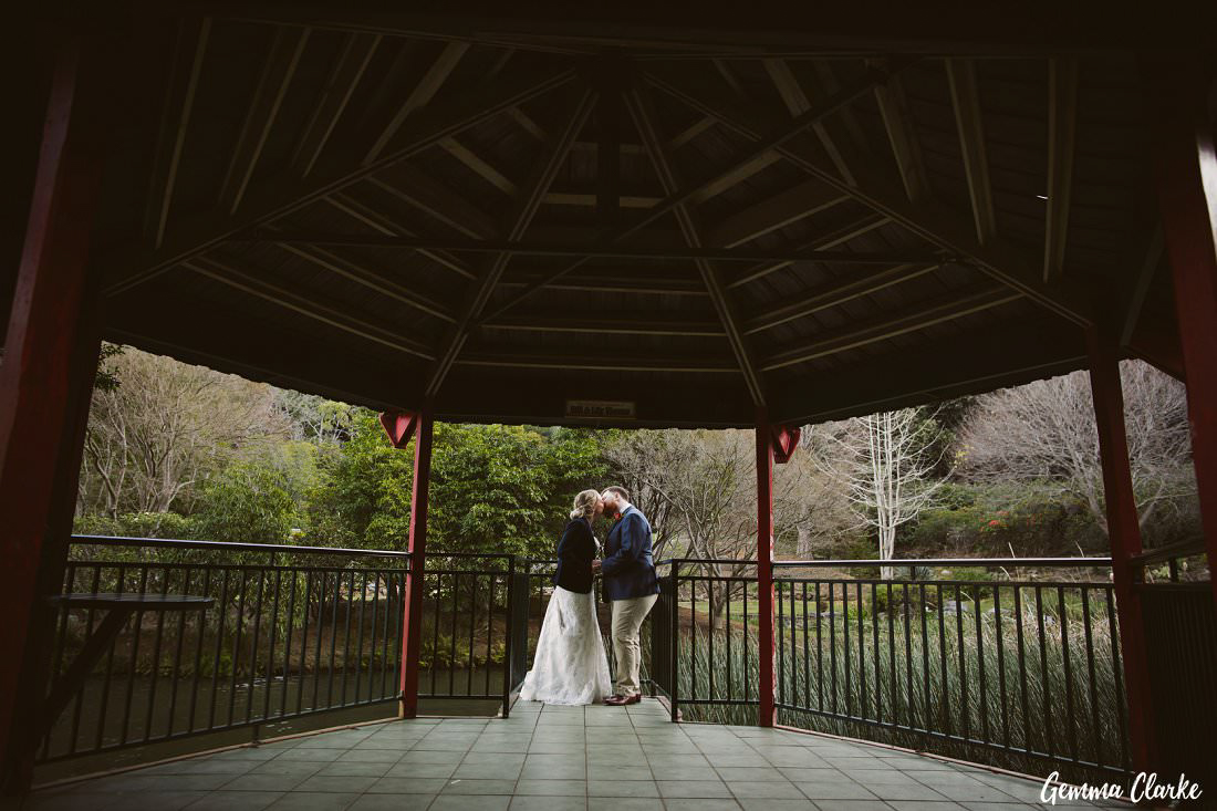 Kissing under the gazebo at Rhododendron Gardens at this winter wollongong wedding