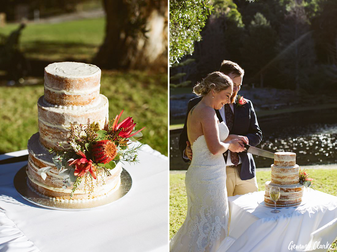 Cutting the cake in the gardens while battling the winds at this winter Wollongong wedding 