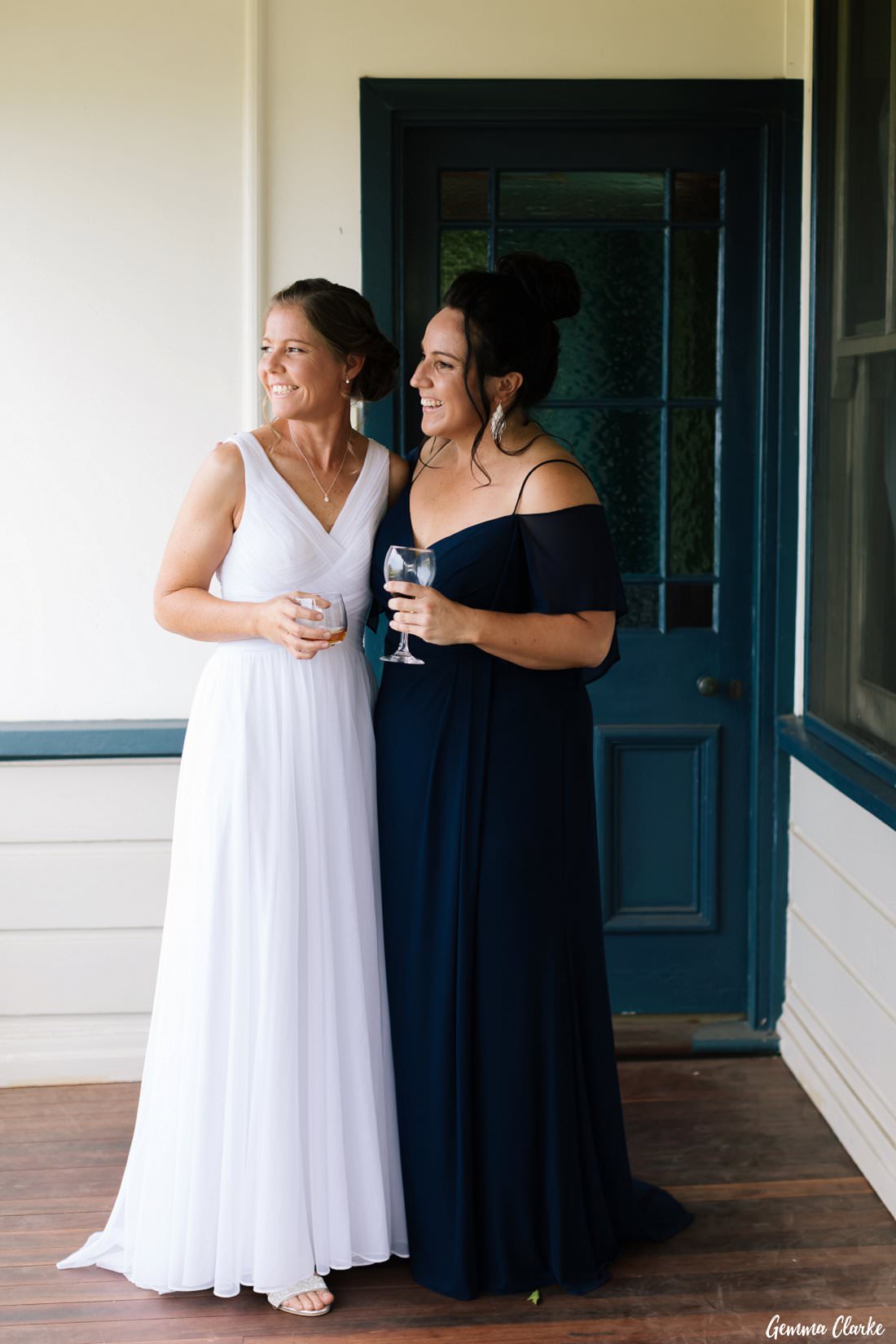The brides have a celebratory drink on the Bush Bank cottage verandah before greeting all their guests. 