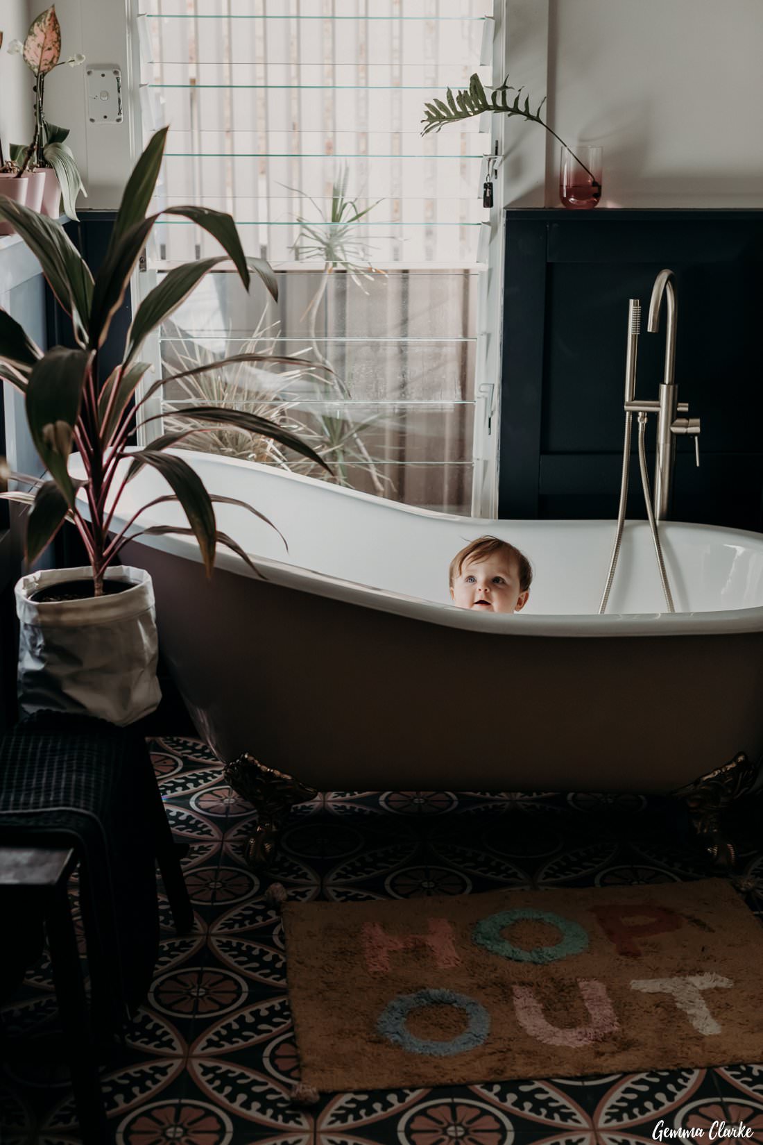 9 month old baby enjoying her antique bath photoshoot with Hop Out novelty bath mat!